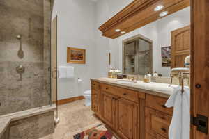 Full bathroom with a shower stall, vanity, and light tile patterned floors