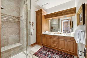 Full bathroom with double vanity, a stall shower, and light tile patterned flooring