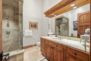 Full bath featuring a shower stall and vanity