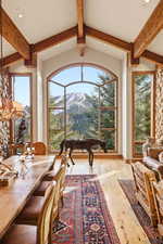 Dining room featuring recessed lighting, beamed ceiling, light wood-type flooring, and a mountain view