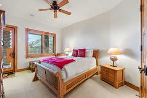 Bedroom featuring a ceiling fan and light colored carpet