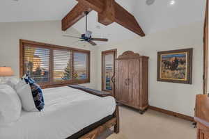 Bedroom featuring multiple windows, light carpet, and ceiling fan