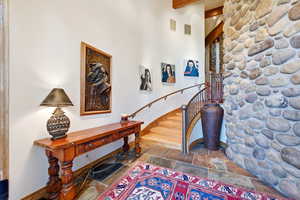Entrance foyer with stone tile floors and baseboards