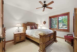 Bedroom featuring light carpet and a ceiling fan