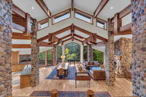 View of patio featuring a wooden deck and an outdoor living space with a fireplace