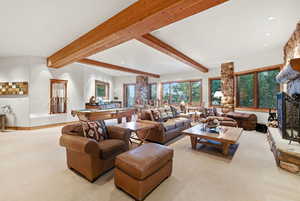 Carpeted living room with a fireplace, recessed lighting, billiards, and beam ceiling