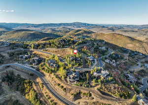 View of property location with mountains and nearby suburban area
