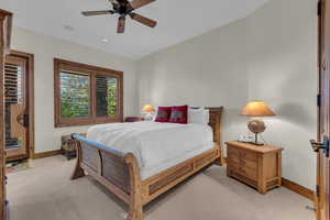 Carpeted bedroom featuring a ceiling fan and recessed lighting