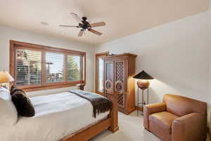 Bedroom featuring a ceiling fan and light colored carpet