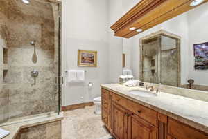 Bathroom featuring vanity and a shower stall
