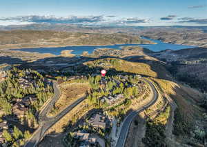 Aerial view of property and surrounding area featuring a water and mountain view