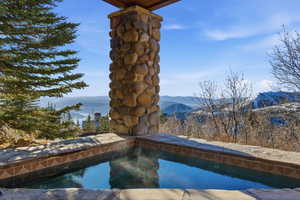 Outdoor pool featuring a balcony and a mountain view