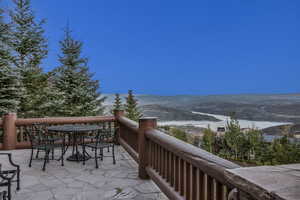 Balcony featuring outdoor dining area and a mountain view