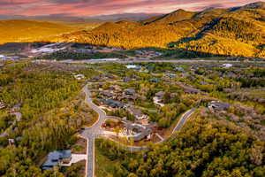 Aerial view of property's location featuring a mountainous background