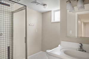 Bathroom featuring toilet, a shower stall, vanity, baseboards, and tile patterned floors