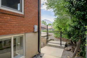 View of home's exterior with brick siding and a gate