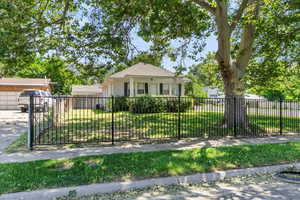 The fully fenced yard is perfect for relaxing or entertaining, with mature shade trees, fruit trees, and beautiful mountain views