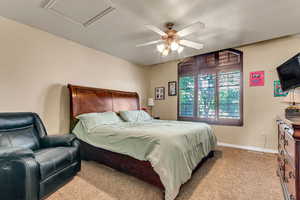 Carpeted bedroom with baseboards and a ceiling fan