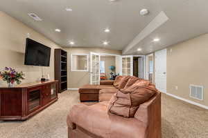 Living area featuring light carpet, baseboards, french doors, and recessed lighting
