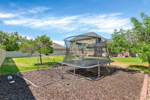 Back of property with a trampoline