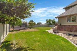 View of yard with a trampoline and a patio area