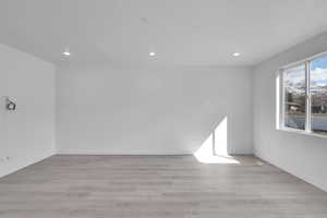 Spare room with recessed lighting, light wood-style flooring, and baseboards