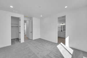 Unfurnished bedroom featuring carpet flooring, recessed lighting, a spacious closet, and baseboards
