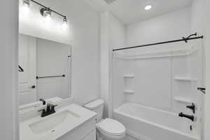 Full bath featuring vanity, shower / bathtub combination, toilet, and recessed lighting