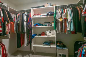 Walk in closet with carpet flooring