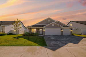 Craftsman inspired home featuring a garage, board and batten siding, driveway, brick siding, and a porch