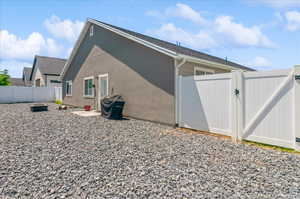 View of home's exterior with a gate and a fenced backyard