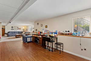 Bar featuring wood finished floors and baseboards