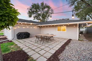 Patio terrace at dusk featuring a patio area, a grill, and central AC