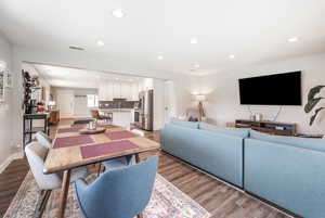 Dining room with light wood-type flooring, recessed lighting, and baseboards