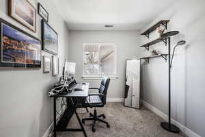 Carpeted home office with baseboards