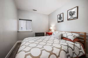 Bedroom featuring carpet and baseboards