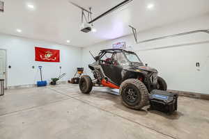 Garage with a garage door opener and recessed lighting