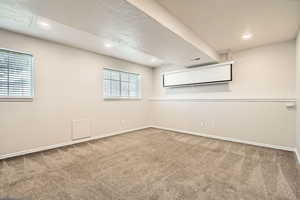 Carpeted empty room with baseboards and recessed lighting