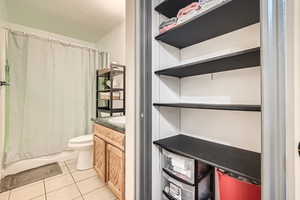 Full bathroom featuring tile patterned floors, toilet, and vanity