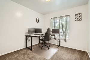 Home office featuring carpet floors and baseboards