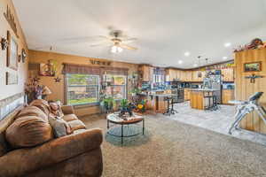 Living room featuring ceiling fan and recessed lighting