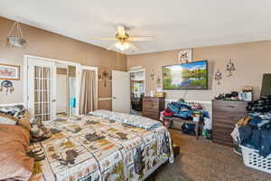 Bedroom featuring carpet flooring, ceiling fan, and french doors
