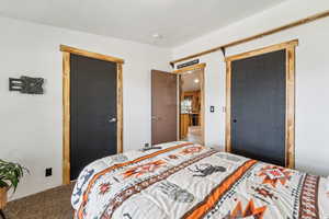 Carpeted bedroom featuring a closet