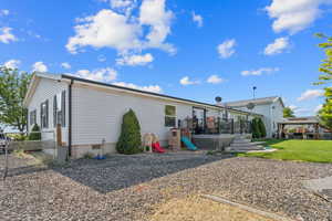 Rear view of house with a deck and a gazebo