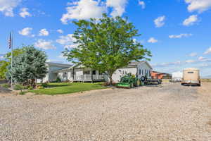 View of front of home featuring gravel driveway