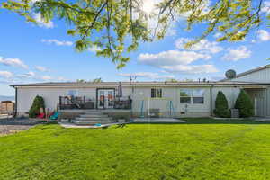Back of house with a deck, french doors, a lawn, and crawl space
