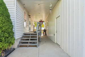 View of exterior entry featuring covered porch