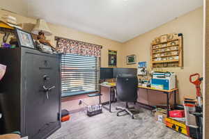 Home office with wood finished floors