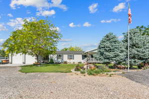 View of front of home featuring concrete driveway, a porch, a garage, and a front yard