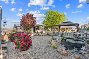 View of yard featuring a gazebo, an exterior structure, and an outbuilding